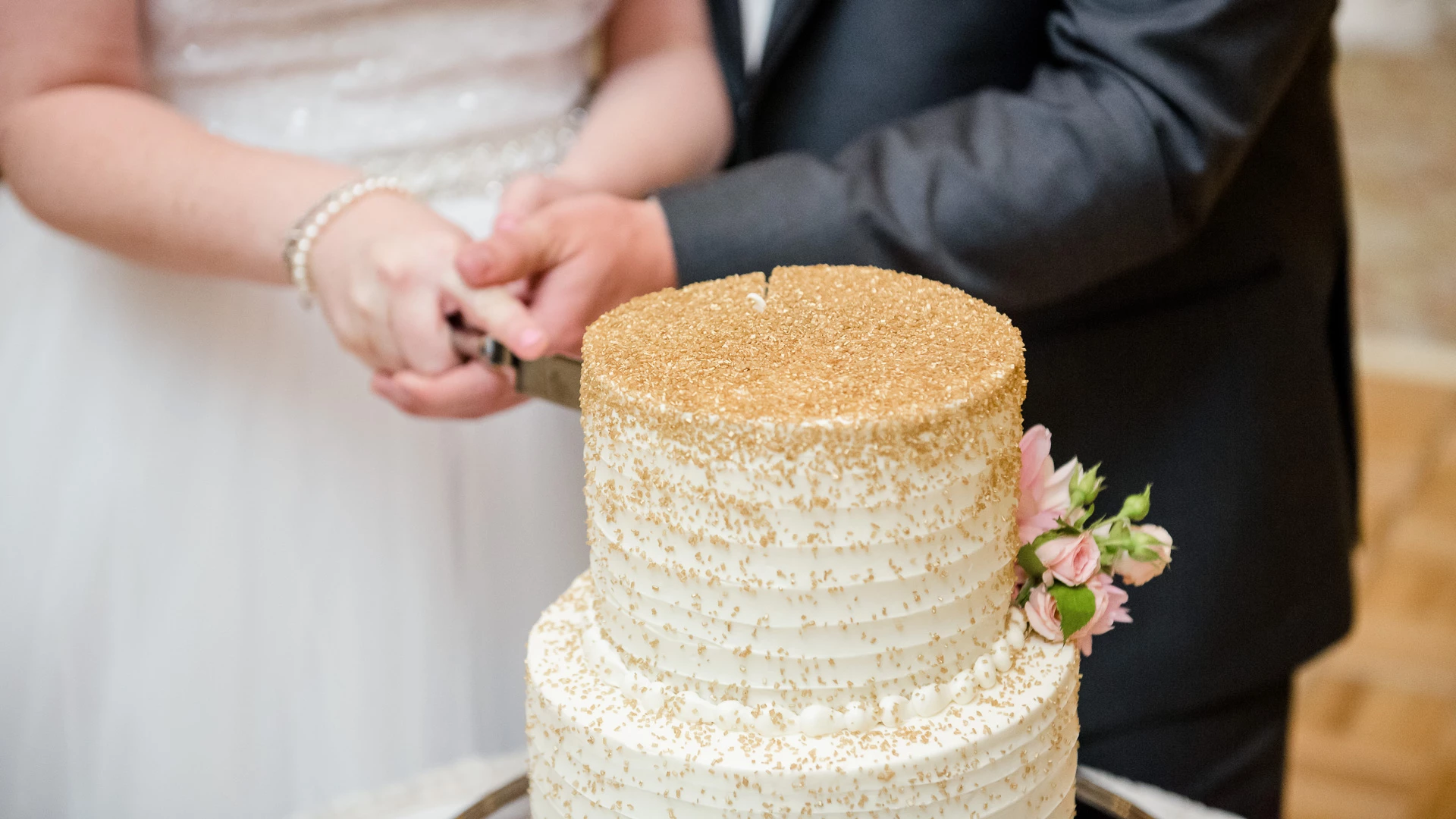 a couple cutting a wedding cake