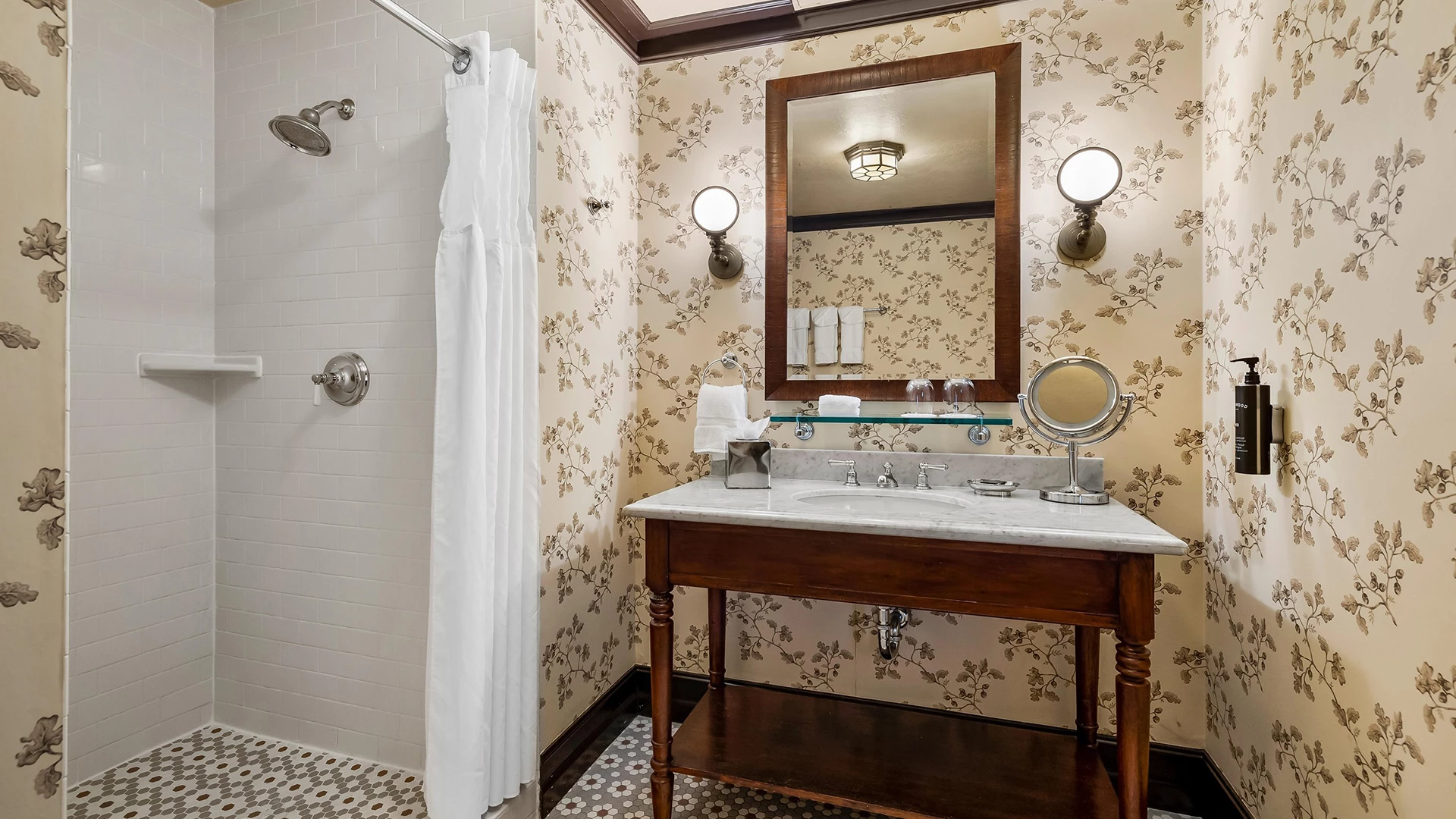 A bathroom with a shower, sink, and mirror