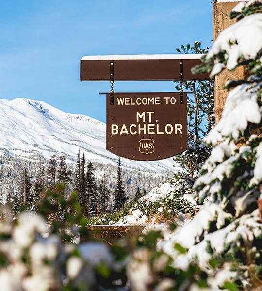a sign with snow on the side