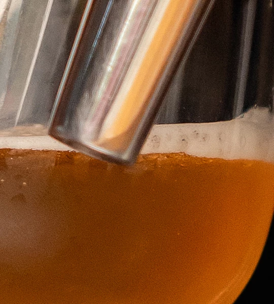 a close up of a glass with a straw