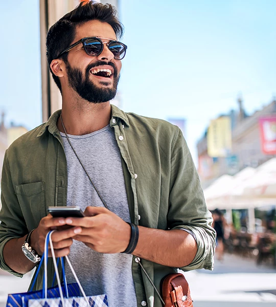 a man holding a bag and a phone