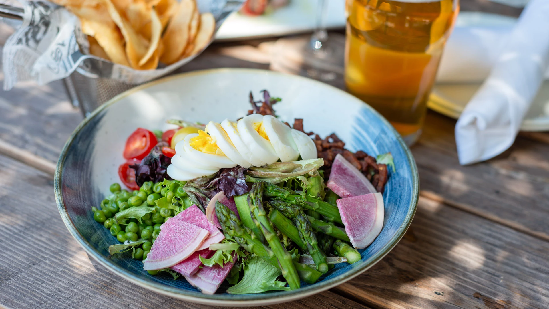 a bowl of salad with eggs and vegetables