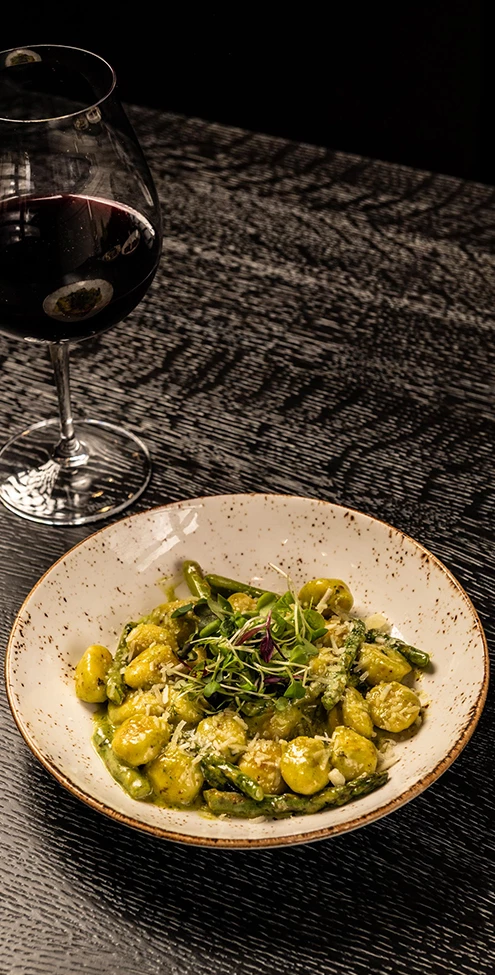 a plate of food and a glass of wine