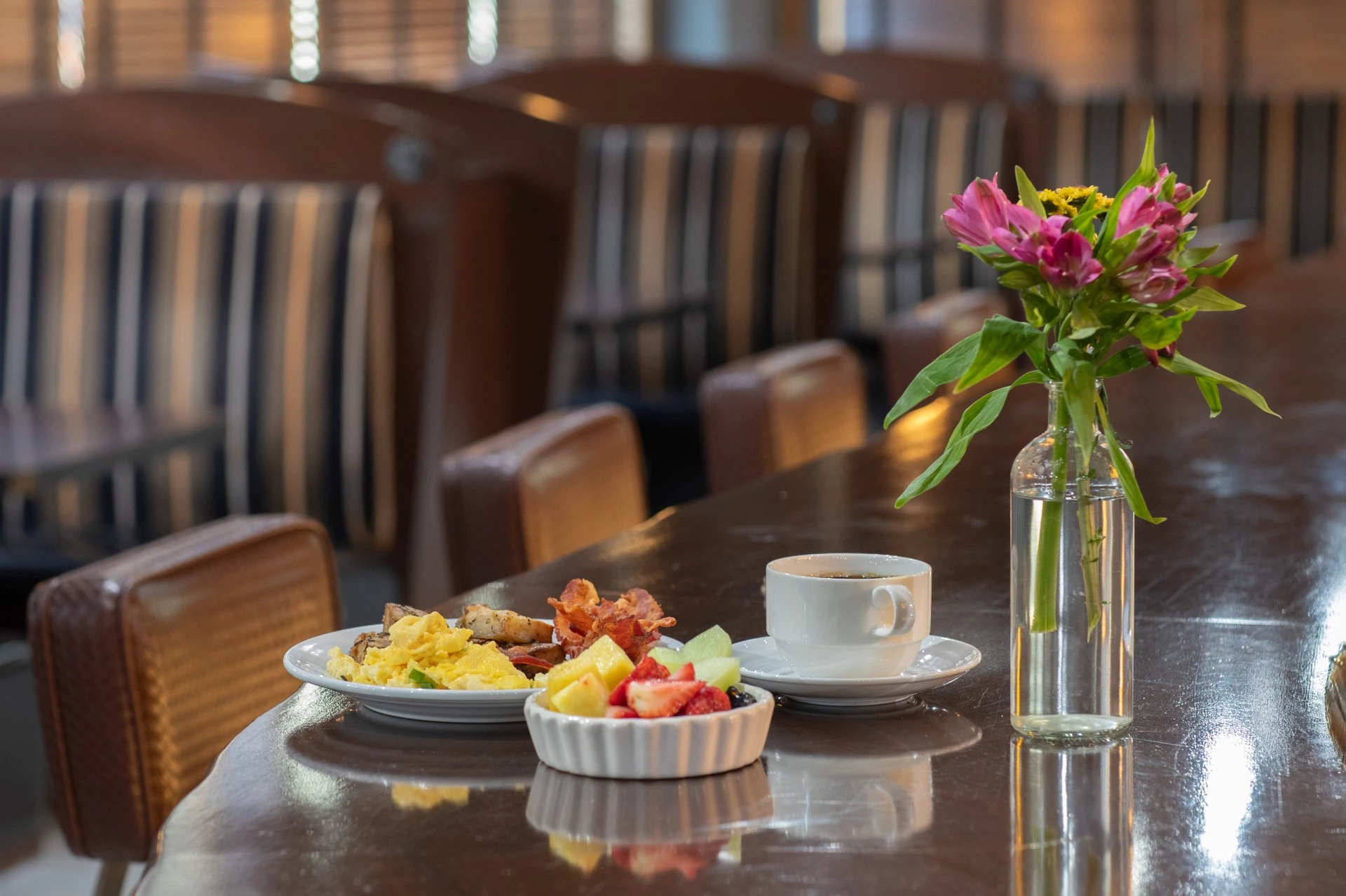 a plate of food and a cup of coffee on a table