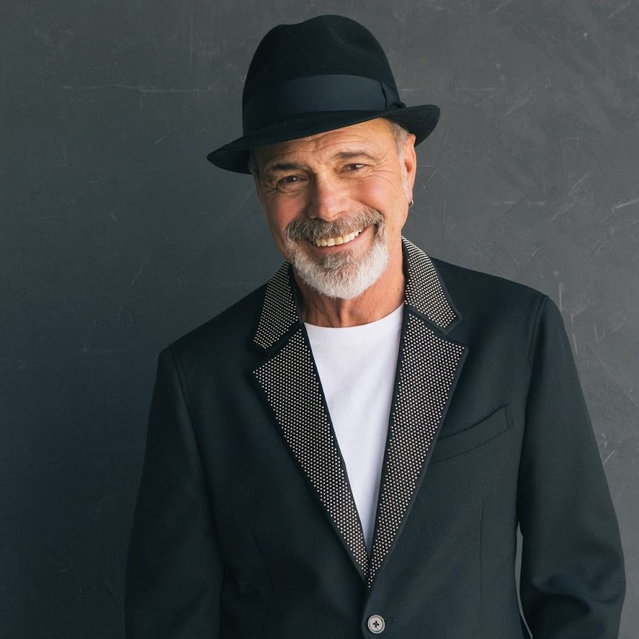 a man in a black suit and hat