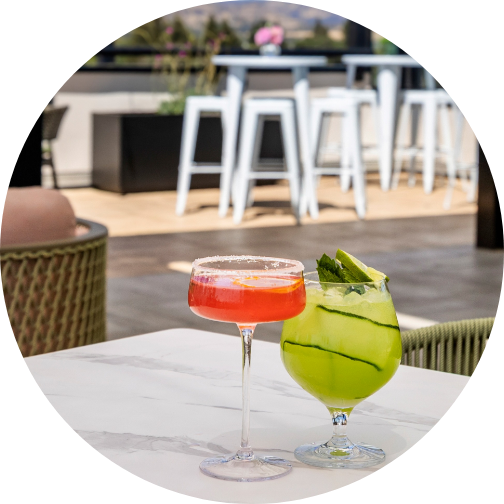 two glasses of drinks on a table