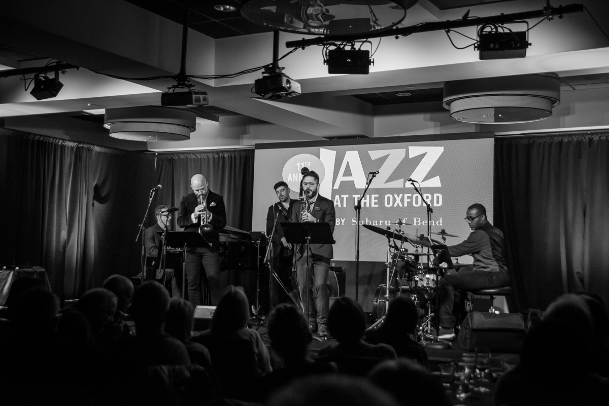 a group of people playing instruments on a stage