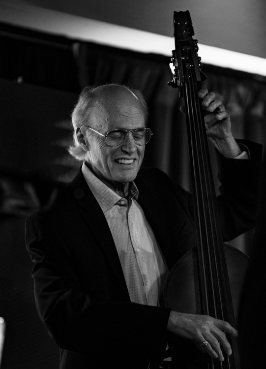 a man holding a cello