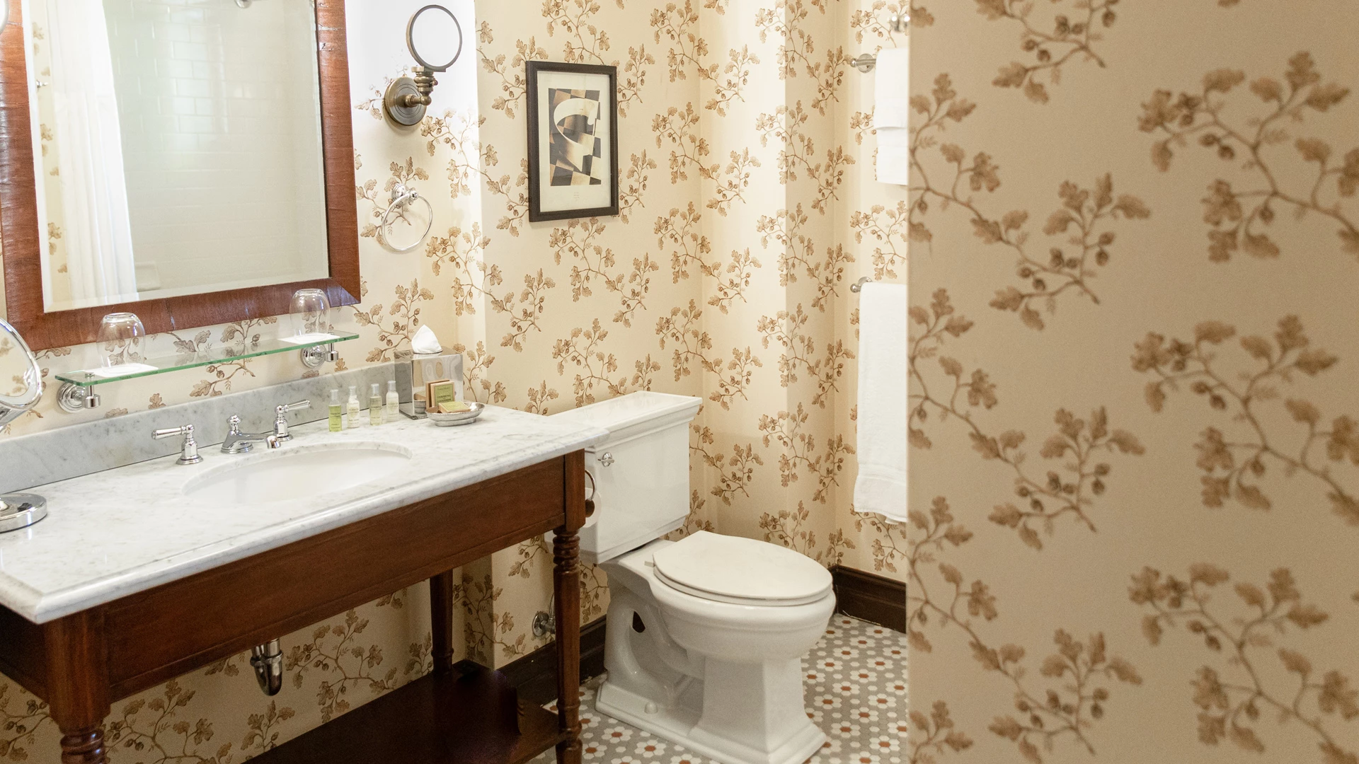 A bathroom with a sink, toilet, and mirror