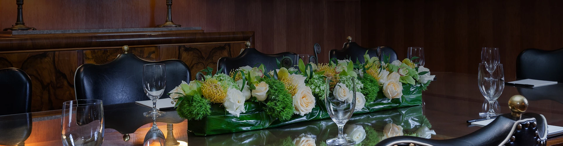 a table with flowers and wine glasses