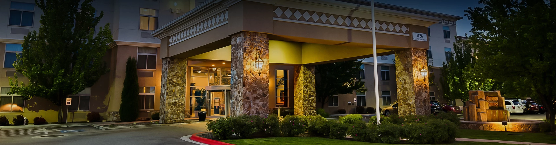 a building with a stone pillar and a light on the side