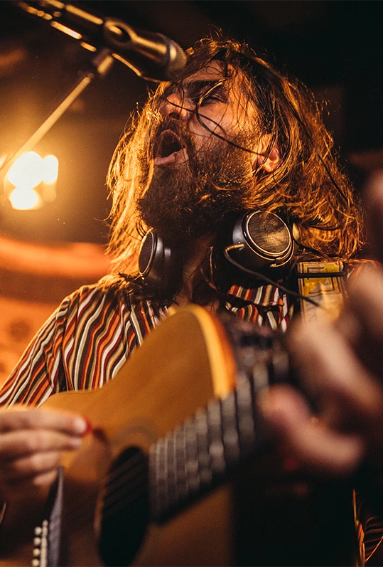 a man with long hair and beard playing guitar