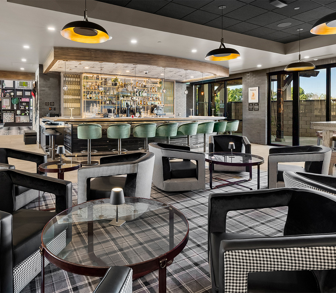 a room with a bar and chairs