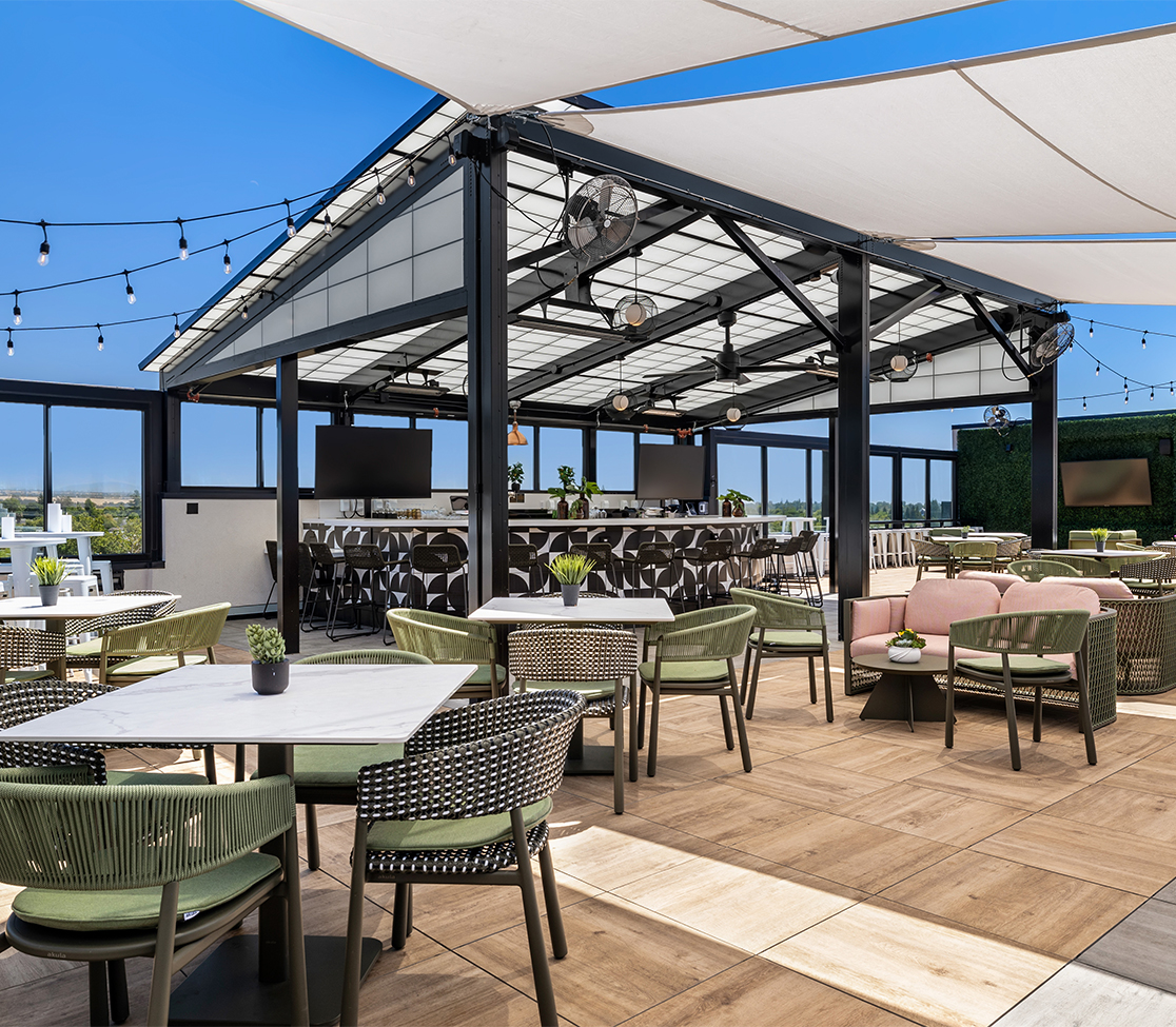 a patio with tables and chairs