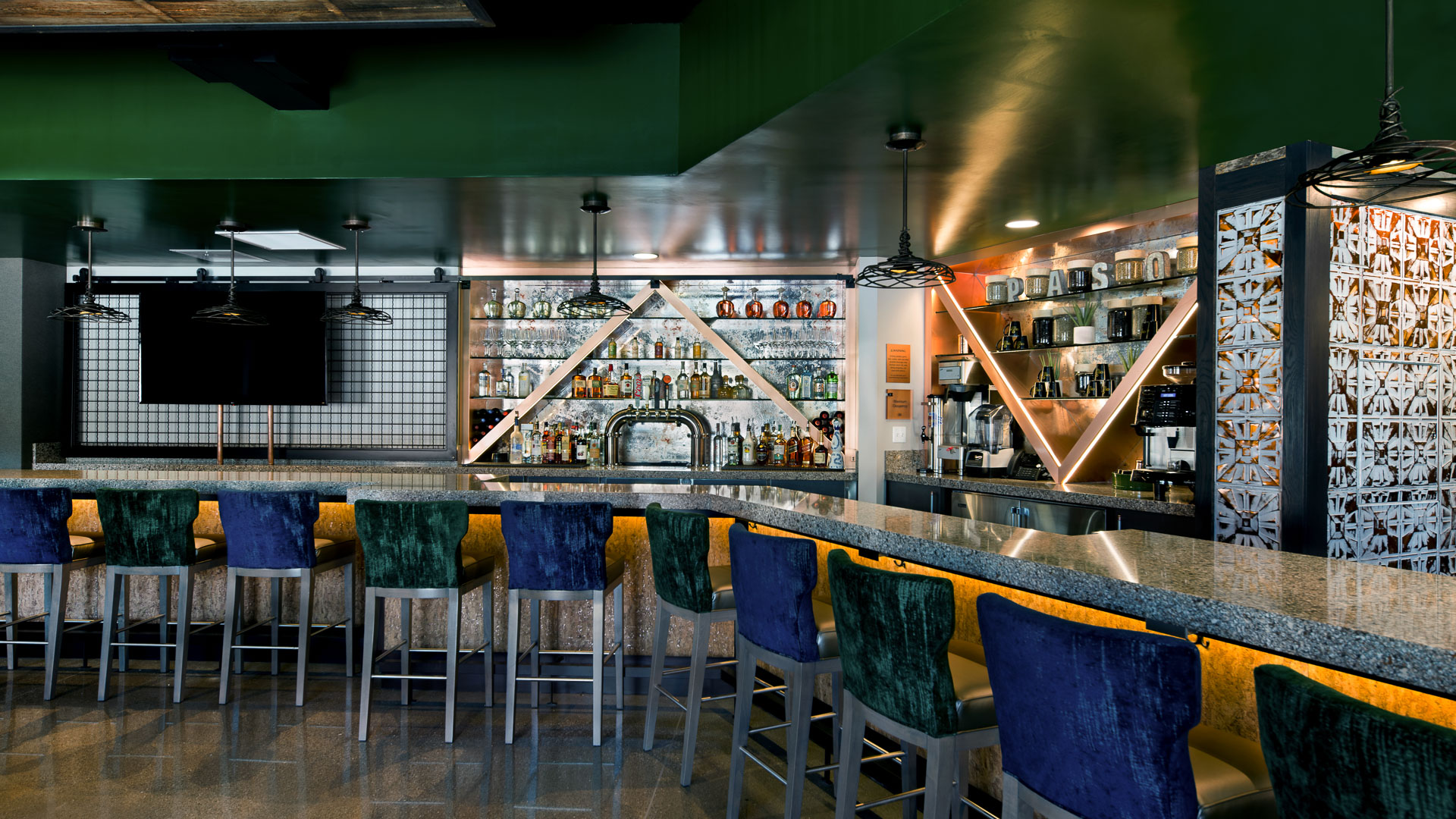 a bar with colorful chairs and a counter