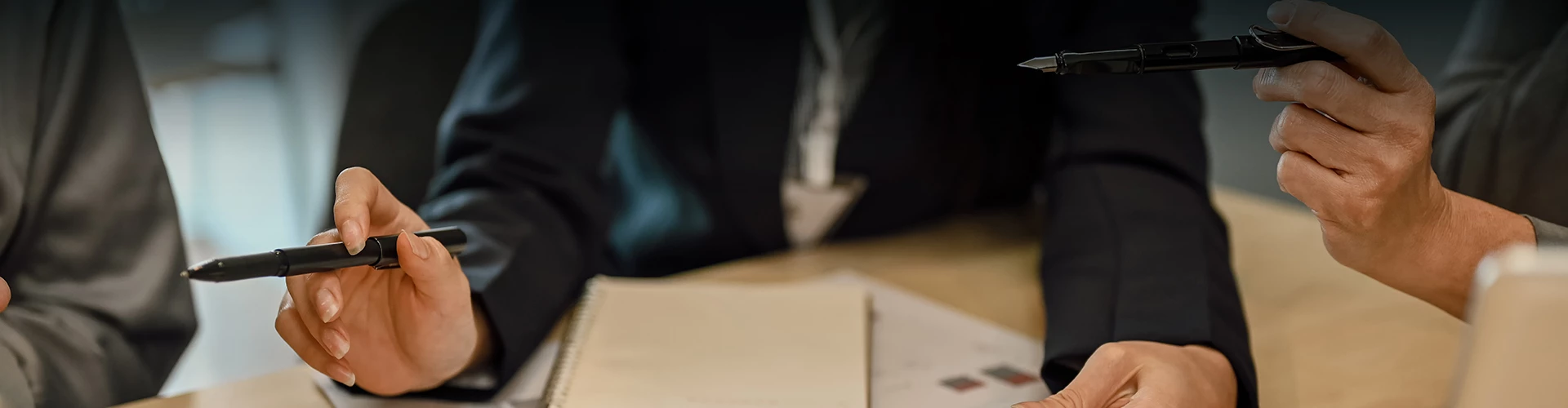 a blurry image of a person's hand holding a notebook