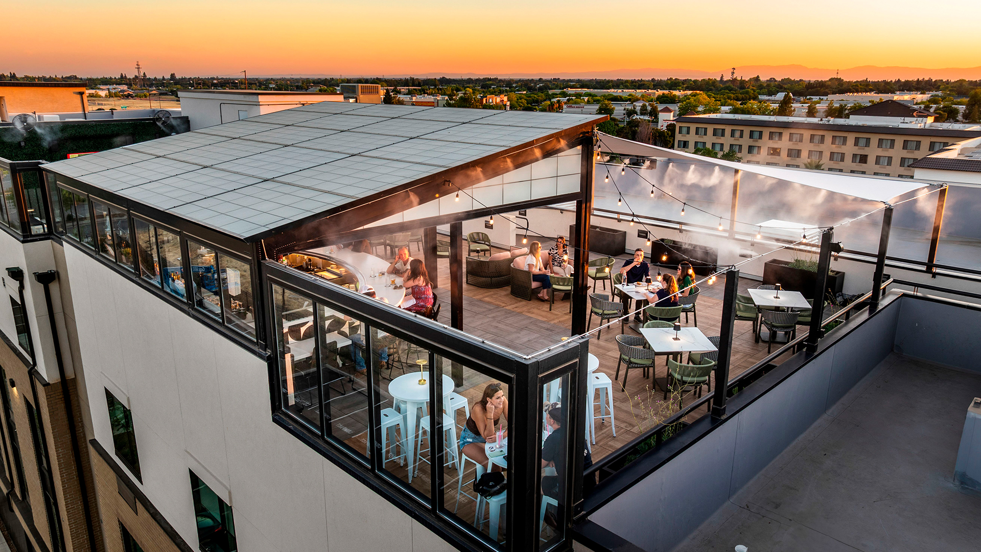 a group of people sitting at tables outside a building