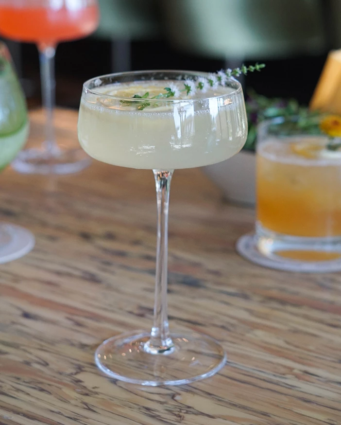 a glass with a drink on a table