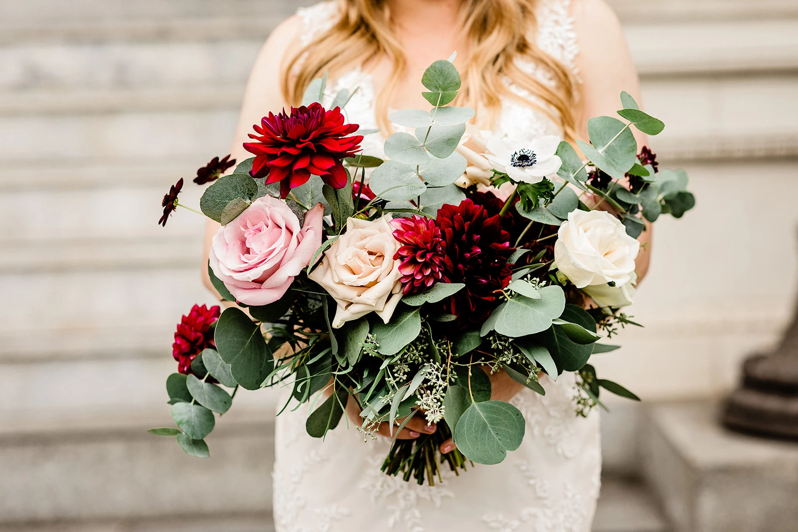 a woman holding a bouquet of flowers
