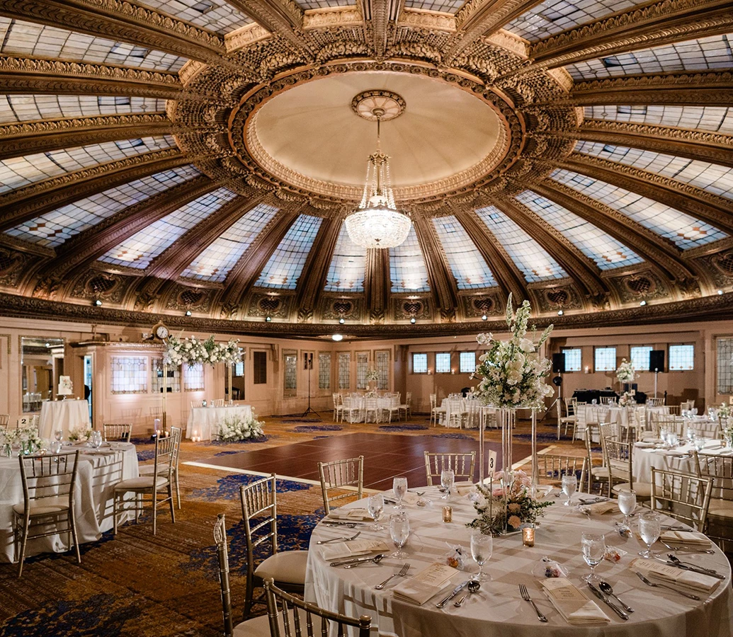 a large round ballroom with tables and chairs