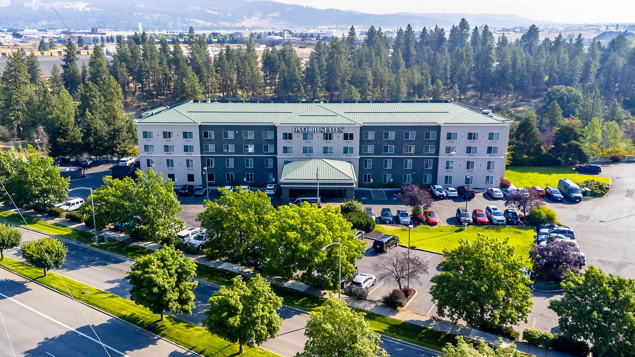 a building with trees and a parking lot