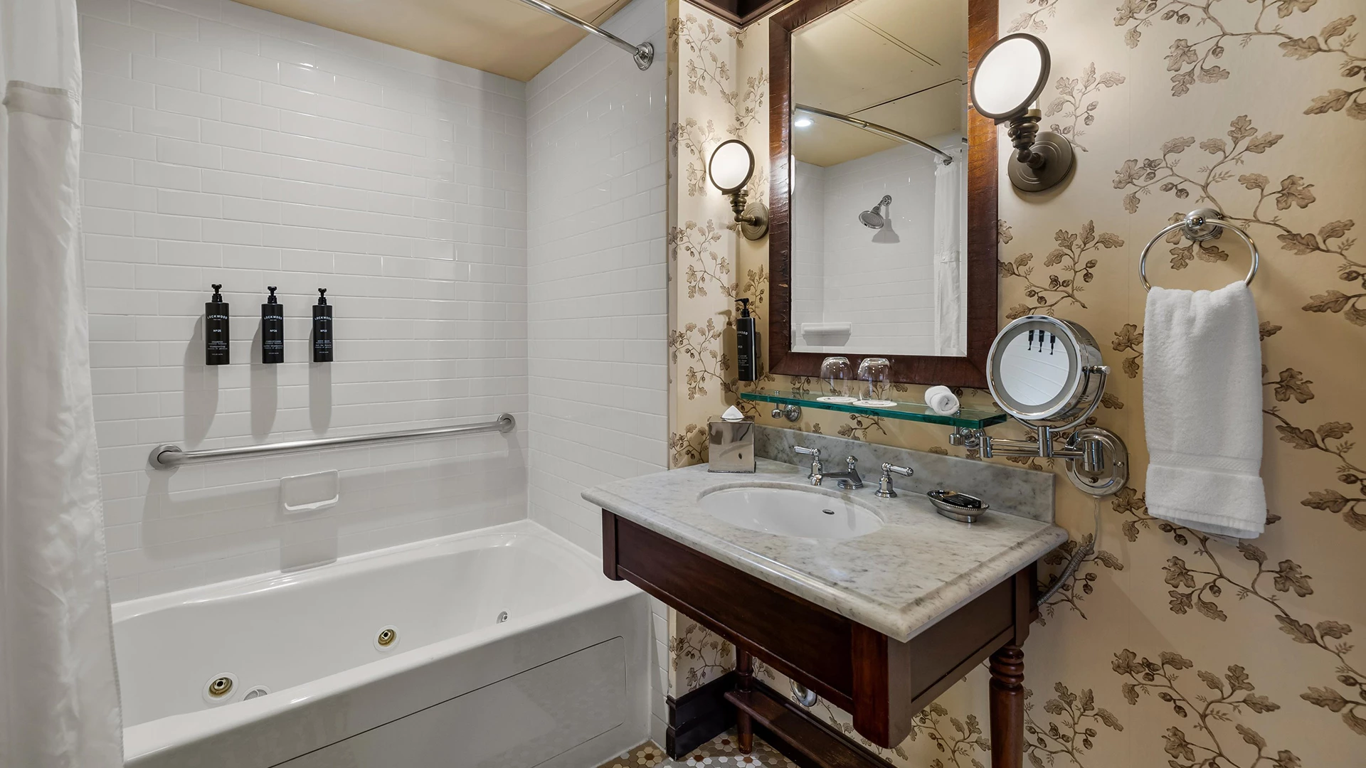 A bathroom with a bathtub, sink, and mirror