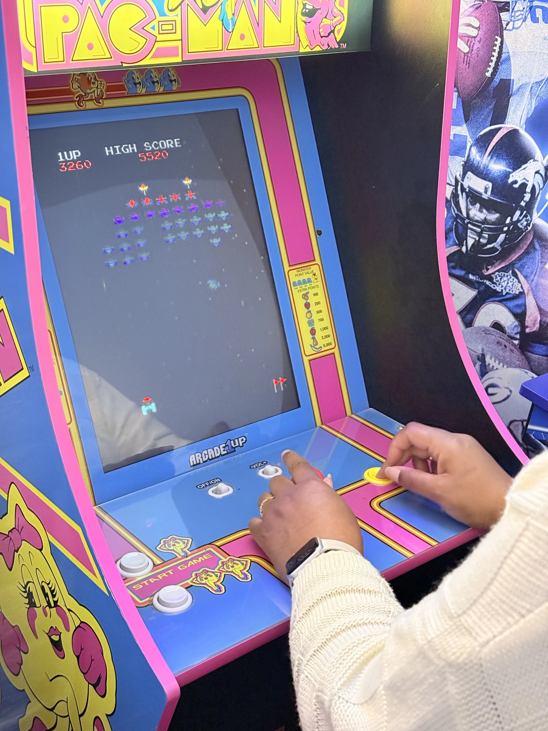 a person playing an arcade game