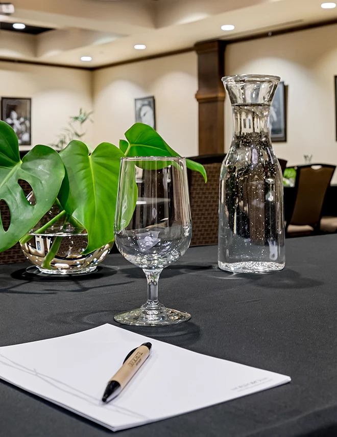a glass and a vase on a table