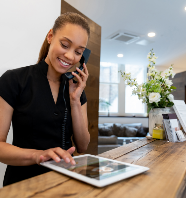a woman on the phone and looking at a tablet