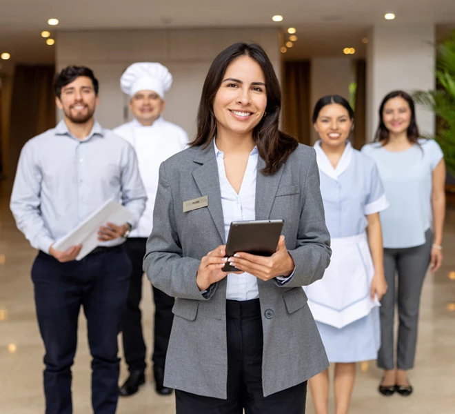 a woman holding a tablet and a group of people in a room