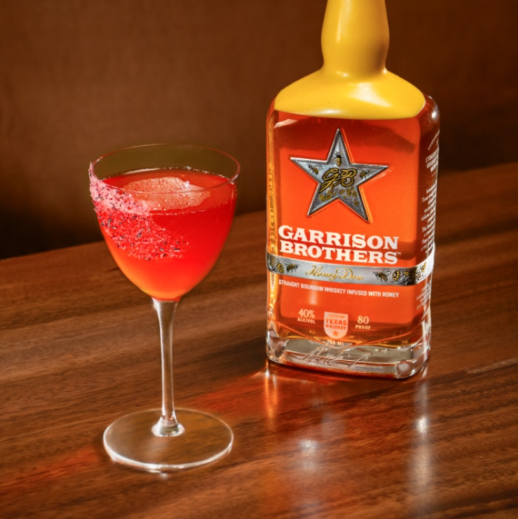 a bottle of alcohol next to a glass of liquid