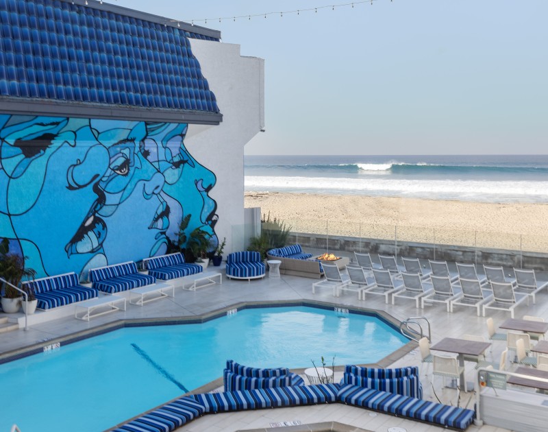 a swimming pool with chairs and a wall of chairs on the side