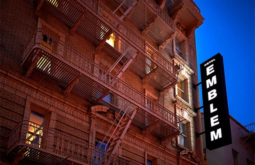 a building with balconies and a sign on the side