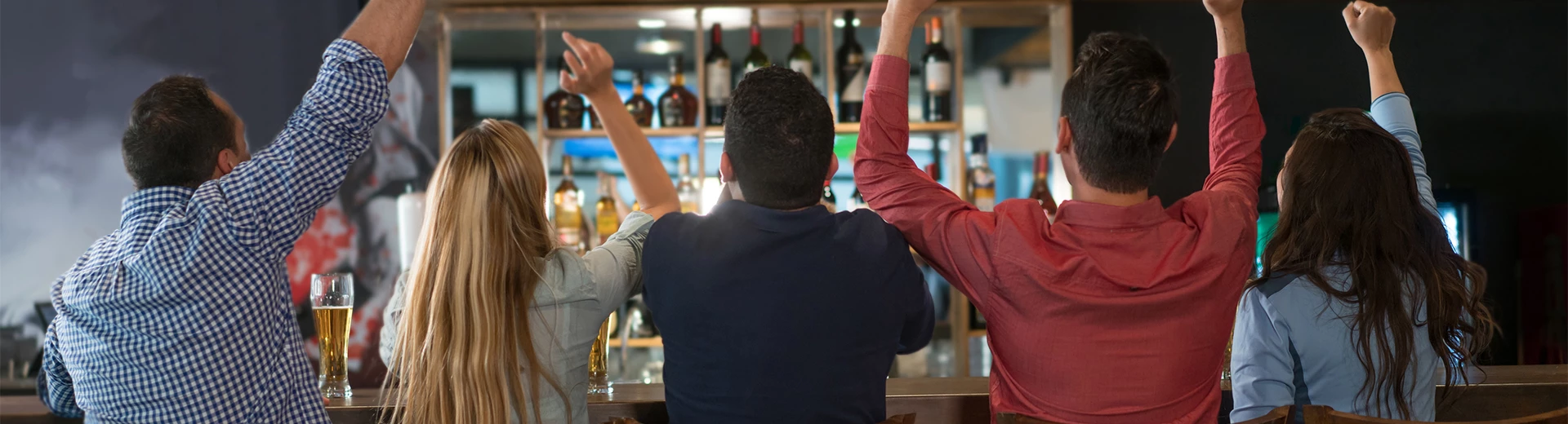 a group of people sitting at a bar