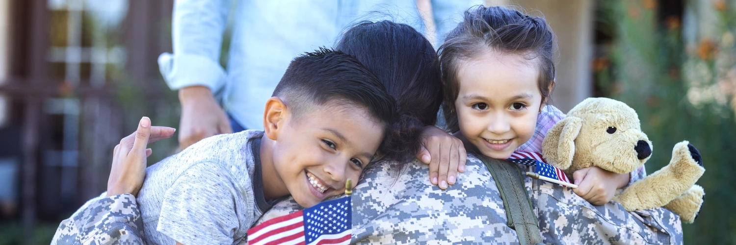 a group of children hugging a man