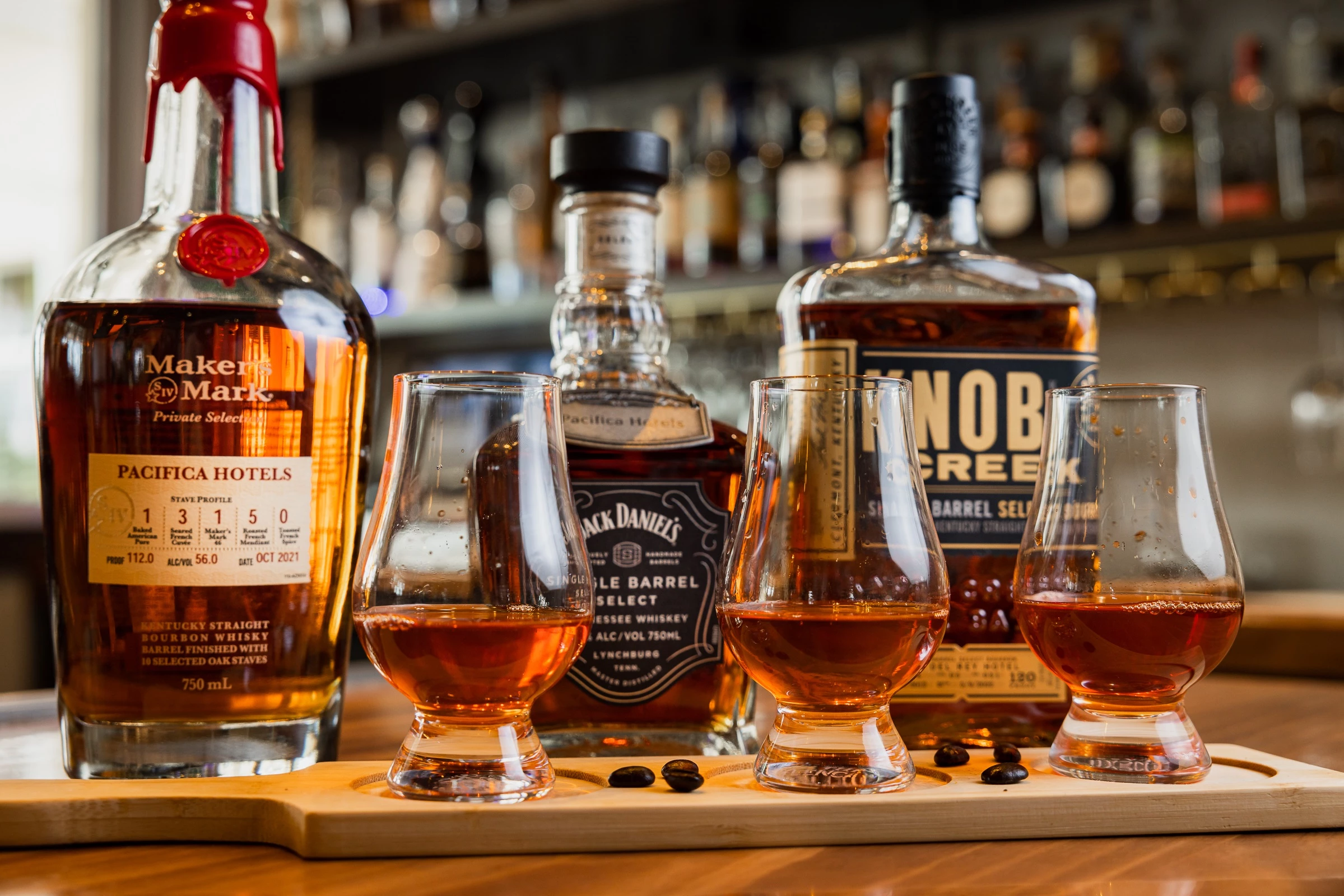 a group of bottles of alcohol on a wooden board