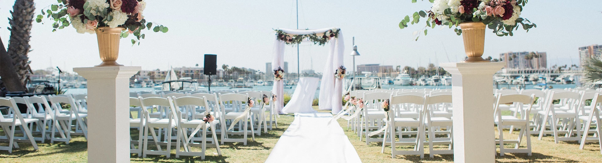 a wedding ceremony with a vase of flowers