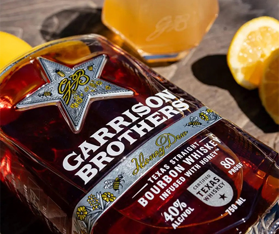 a bottle of liquor next to lemons