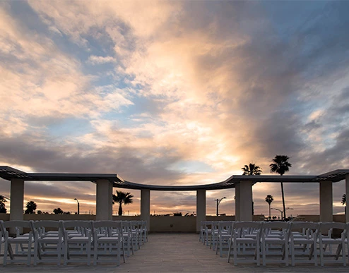a beach with chairs and tables