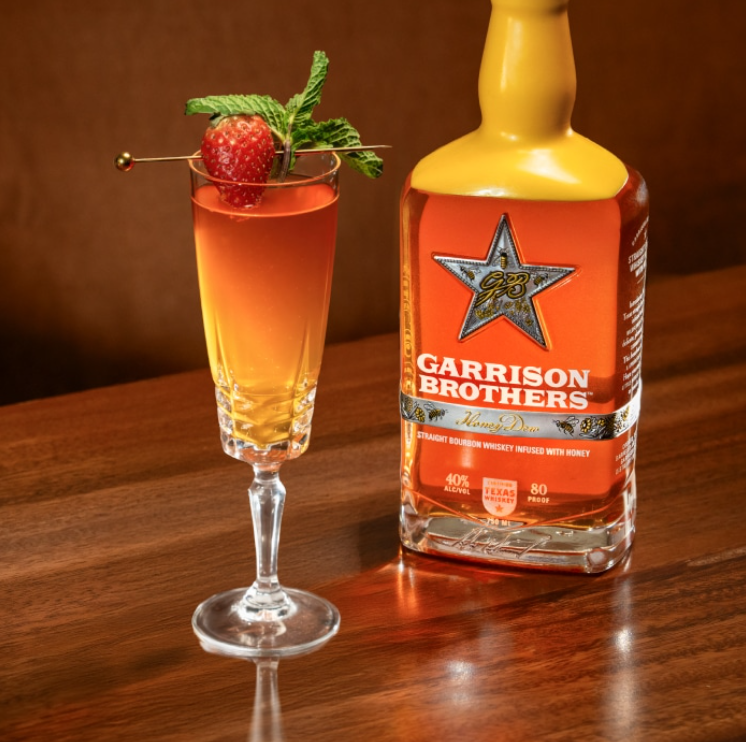a bottle of alcohol next to a glass of liquid