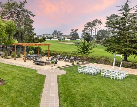a large lawn with chairs and tables