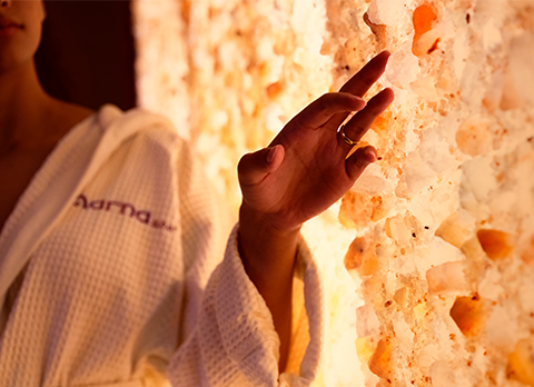 Woman touching a rock salt rock in a spa