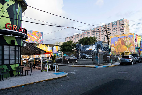 a street with cars and a building