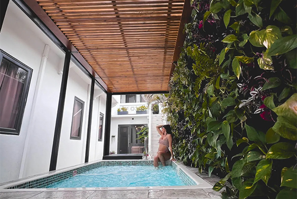 a woman in a garment leaning on a pool