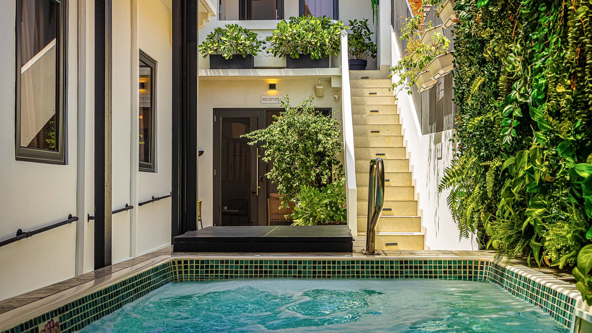 a pool with stairs leading to a building