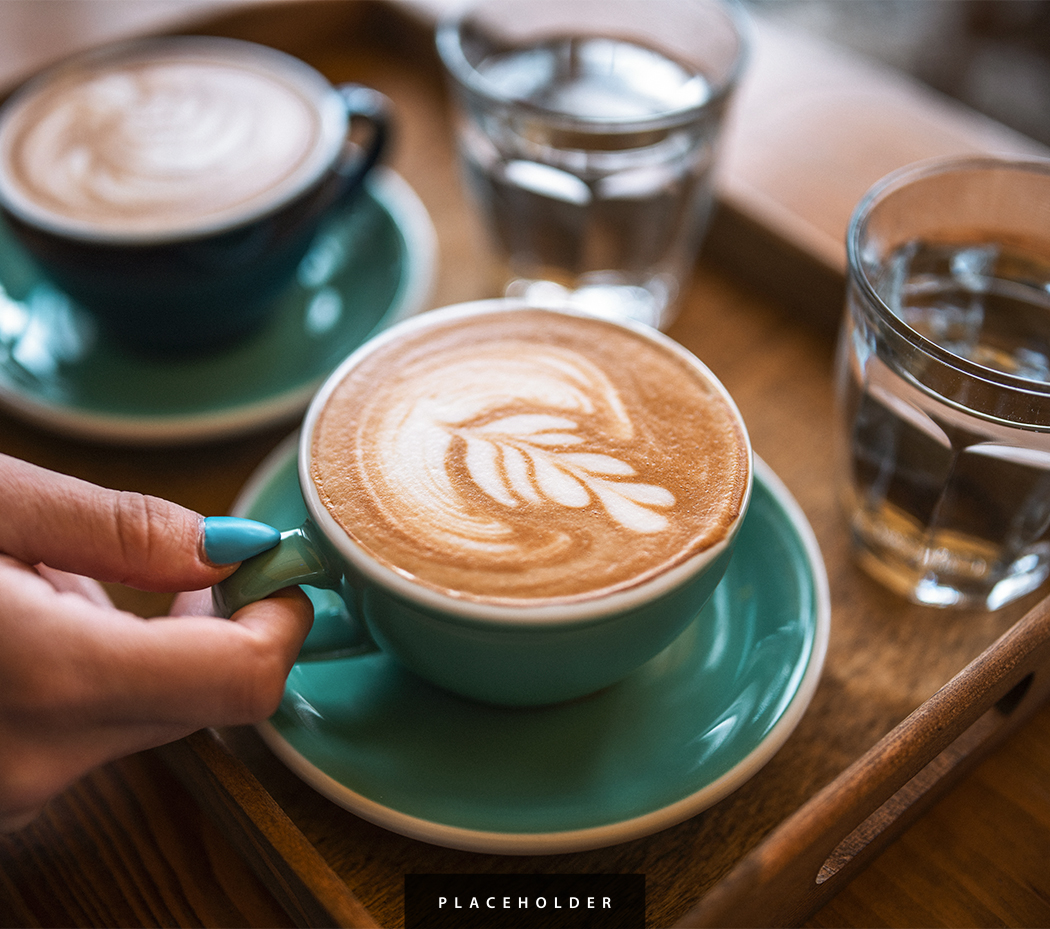 a person holding a cup of coffee
