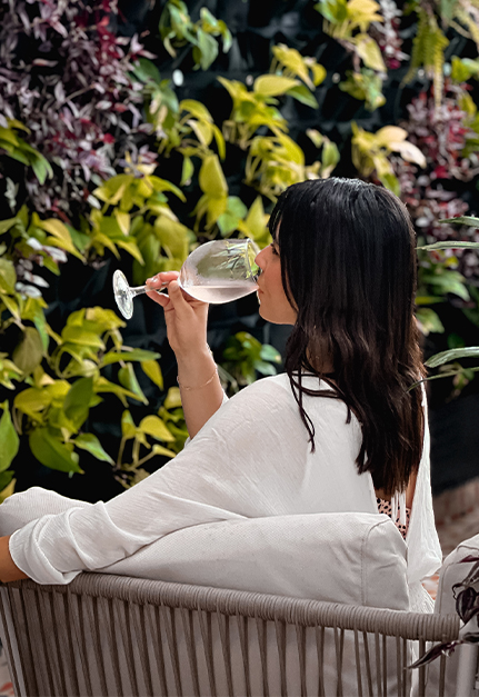 a woman drinking from a glass