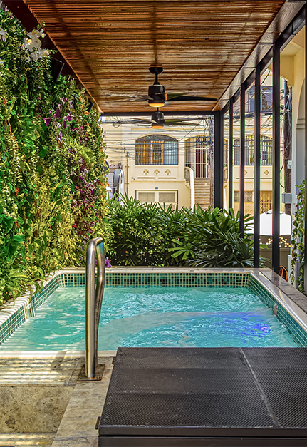 a pool with a metal railing and a fan