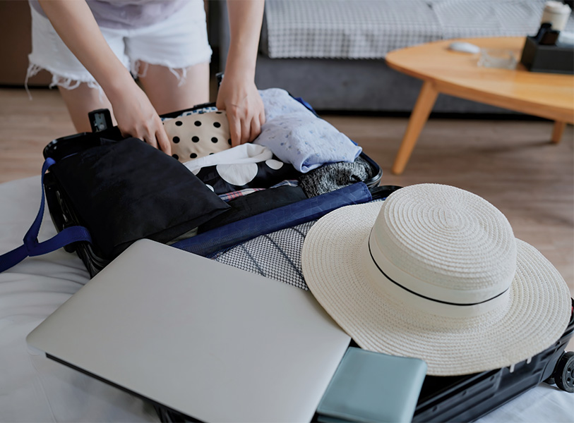 a woman packing a suitcase