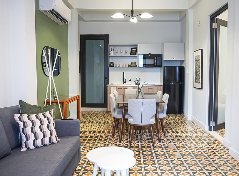 a living room with a table and chairs